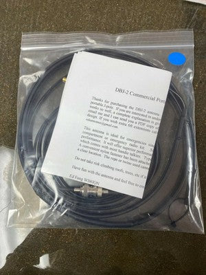 Ed Fong DBJ-2 commercial and GMRS antenna kit in its clear packaging, with blue sticker, coiled antenna and instruction sheet.